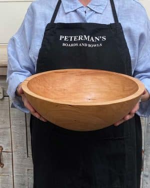 Medium 13-inch cherry round wooden bowl, classic style with warm cherry tones and fine grain.
