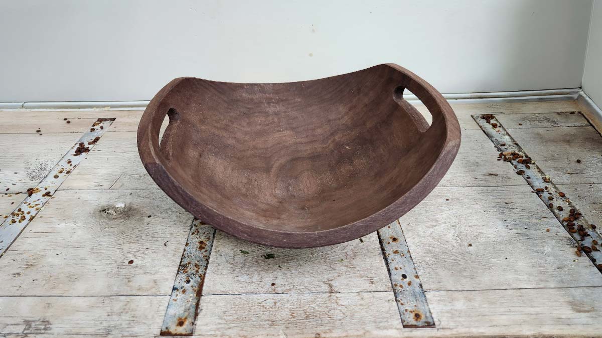 Heirloom gifts for mom black walnut wooden bowl with carved handles, showing rich grain and hand-shaped form